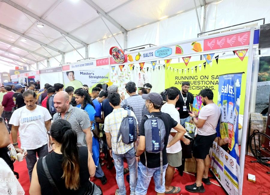Crowd of runners at an expo hydration and sponsor booth