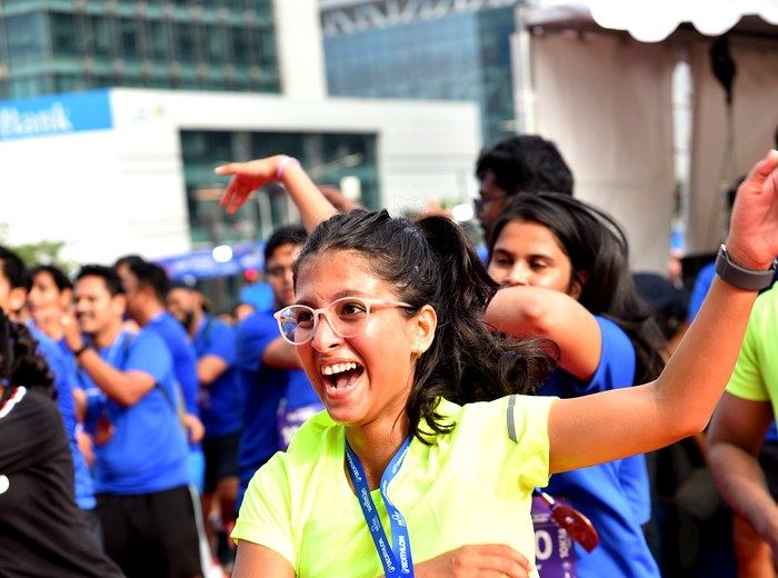 Participant dancing and celebrating at a post-run activation during an Abunduntia-managed event